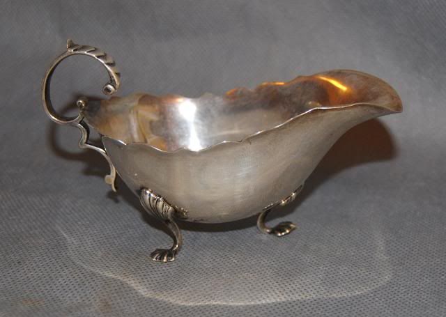 Measures 2 3/4 high, 5 long over spout and handle approx.